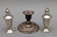 Front view of the tarnished sterling silver Birks candleholder and matching salt and pepper shakers