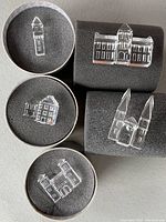 Five crystal buildings displayed on foam inserts.