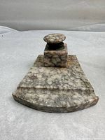 Front view of the antique Carrera marble ink well pen stand featuring the square ink reservoir on a trapezoidal marble base.