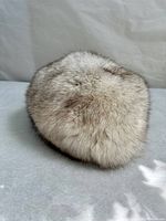 Top view of the silver fox fur hat showing dense, natural fur with grey and brown markings.