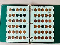 Another open album page showing Canadian Small Cents from 1950 to 1957 with copper pennies in slots