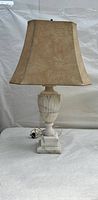 Full view of the vintage alabaster table lamp with beige fabric shade against white backdrop