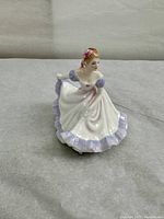 Front view of Royal Doulton Ninette figurine showing detailed hand-painted features and dress design.