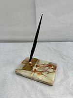 Full view of the Sheaffer fountain pen mounted upright on the Parker marble desk stand showing pen and base details.