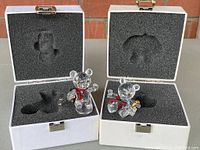 Two Swarovski crystal teddy bears in white boxes with fitted black foam inserts, both in mint condition.