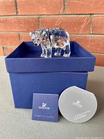 Polar bear figurine on lid of blue Swarovski box with certificates