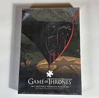 Front view of sealed Game of Thrones 1000-piece puzzle box featuring the 'Violence Is A Disease' artwork and branding.