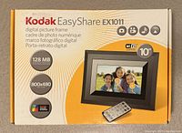 Front of the Kodak EasyShare EX1011 digital picture frame box showing the model, features like 128 MB memory, 800x480 resolution, 10 inch WiFi screen, and included remote control.
