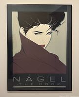 Framed promotional poster titled 'Nagel The Book,' showing a stylized female portrait with black hair and high collar, mounted under glass in black frame.
