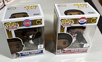 Photo of two unopened Funko Pop vinyl figures of basketball legends Isiah Thomas (Detroit Pistons, #101) and Julius Erving (Philadelphia 76ers, #107).