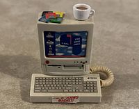 Front view showing detailed vintage computer and accessories on top.