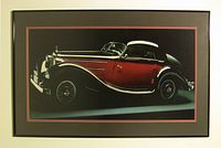 Vintage black and red Mercedes car image mounted under glass in black frame with red trim, shown from front.
