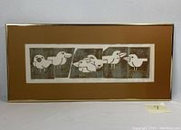 Full framed monoprint showing six stylized birds in rectangular panels with a warm brown matte and gold frame.