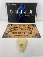 Full set including Ouija board, planchette, and original box showing front design.