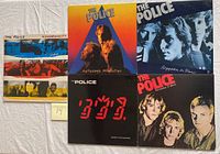 Five vinyl record albums from The Police displayed together, showing front covers for Synchronicity, Zenyatta Mondatta, Reggatta de Blanc, Ghost in the Machine, and Outlandos d'Amour.