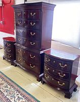 Full view of highboy dresser and two nightstands in dark cherry finish