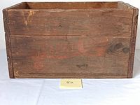 Clear frontal view of the wooden crate showing the faded Pepsi Cola branding and overall condition.
