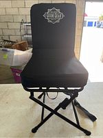 Front view of black Guide Gear folding chair with padded fabric seat and backrest showing logo.