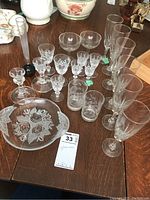 Photo showing full set of 20 crystal glassware pieces including various glasses, vase, and plate.