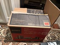 Box of Sony Bravia DAV-HDZ284 DVD Home Theatre System with specifications on side and top showing total output power and HDMI capability.