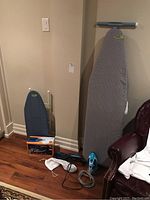 Photo showing large ironing board, smaller ironing board, Panasonic iron, Conair iron, T-Fal steamer, and cords