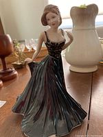 Full view of the Royal Doulton Amelia HN 4327 figurine showing the black dress and posture.