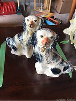 Front view of both figurines showing painted details and overall form