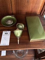 Overview of the entire set including the ashtray with silver insert, lighter parts, and the case on wooden surface.