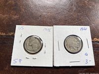 Photo of two US Buffalo nickels dated 1918 and 1920 in white holders showing obverse sides with Native American profile.