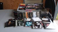 Jewel case CDs stacked and spread on a table, includes various artists and genres with a focus on jazz.