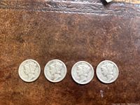 Four US Mercury Dimes front view, showing Liberty profile with winged cap.