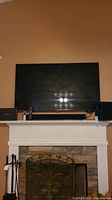 Samsung flat-screen TV mounted above fireplace