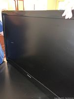 Front view of the Philips flat-screen TV showing the black bezel and screen.