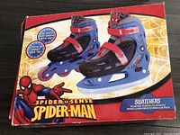 Closed box showing Spider-Man branding and image of adjustable skates that convert between ice and inline roller blades.
