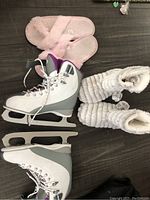 Top view of the ice skates showing laces and slippers alongside