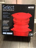 Front of the product box showing brand, product name, image of assembled red microwave pressure cooker, and capacity 3.2L