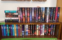 Shelf with multiple rows of J.A. Jance paperback novels, spines visible showing titles and author name.
