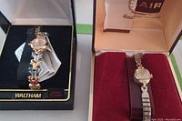 Waltham and Belair ladies watches in their respective boxes, displaying face and bands.