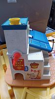 Side view of Fisher Price Cash Register with stickers.