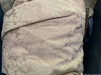 White damask floral patterned fabric folded