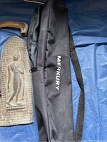 Buddha tin shingle with standing figure, black MERKURY bag and cane handle