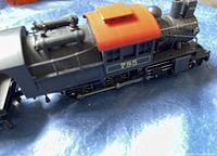 Close-up of electric locomotive marked 785 with red-orange roof