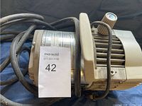 Top-down photo showing the side with the reseller lot number and part of the power cord