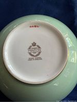 Bottom of the bowl showing the Minton maker's mark stamp in brown with crown and shield emblem and text 'MINTON BONE CHINA MADE IN ENGLAND'.