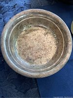 Top view of one silver serving plate showing tarnish and wear