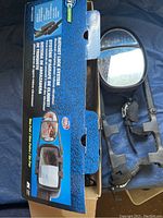 Boxed pair of dual view clip-on towing mirrors showing product features and lock system description.
