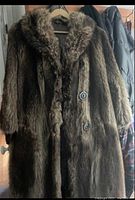 Front view of the women’s real fur coat with button closure, medium brown with dense fur texture