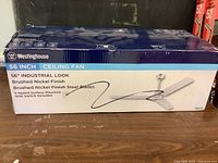 Boxed Westinghouse 56 inch ceiling fan showing brand, size, and finish details