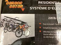 Front of box with Garage Gator branding, demonstration of bicycles on lift, capacity printed