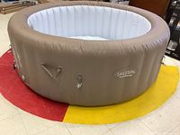 Full view of inflated spa tub on floor, showing overall shape and condition